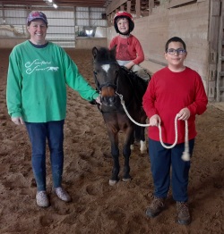 Bethany's student, Troy giving Wyatt a pony ride on Rainbow!